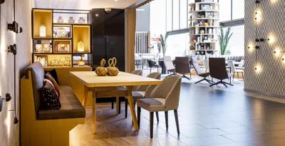 a dining room with a table and chairs at Ilunion Barcelona in Barcelona