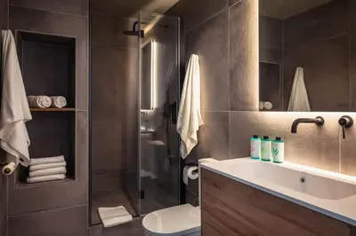 a bathroom with a shower and a sink and a toilet at Lovely 6 BR Flat in L'Eixample in Barcelona