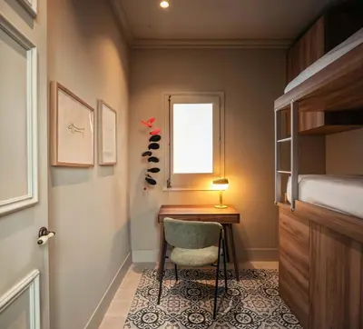 a bedroom with a desk and a window and a bed at Lovely 6 BR Flat in L'Eixample in Barcelona