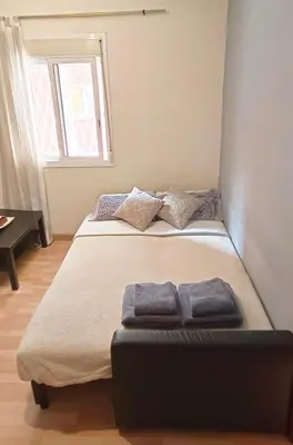 a bedroom with a bed with two towels on it at My best house BCN in Barcelona
