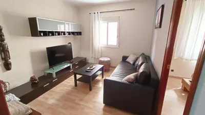 a living room with a couch and a table at My best house BCN in Barcelona