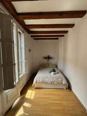 a bedroom with a bed with a wooden ceiling at Habitacion Privada en APARTAMENTO COMPARTIDO in Barcelona