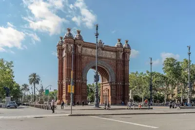 a large building with an arch in a city at Canela Homes BARCELONA BRUC in Barcelona