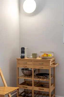 a wooden cabinet with a bowl of fruit on it at Canela Homes BARCELONA BRUC in Barcelona