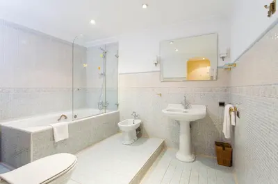 a bathroom with a sink and a toilet and a tub at Charming Central Apartment Big Sunny Terrace! in Barcelona