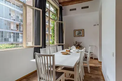 a dining room with a white table and chairs at Canela Homes BARCELONA LIGHT in Barcelona