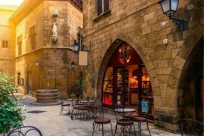 a patio with tables and chairs in front of a building at Canela Homes BARCELONA LIGHT in Barcelona