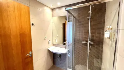 a bathroom with a sink and a glass shower at Dúplex 2 hab con terraza by Prestigi in Terrassa