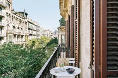 a bedroom with a bed and a large window at Pontone - 2 bedrooms and balcony in Eixample Dreta in Barcelona