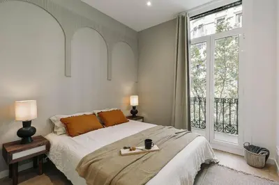 a living room with a couch and a table at Pontone - 2 bedrooms and balcony in Eixample Dreta in Barcelona