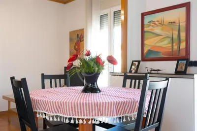 a dining room table with a vase of flowers on it at Bonito alojamiento cerca de Plaza España in Barcelona