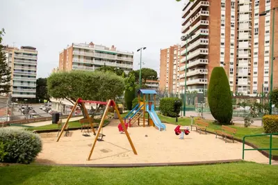 a playground with a swing set in a park at Apartment of 100m2 with sea views in Sant Vicenç de Montalt