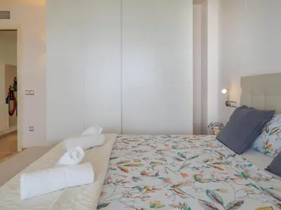 a bedroom with a bed with towels on it at La Perla by Hello Homes Sitges in Sitges