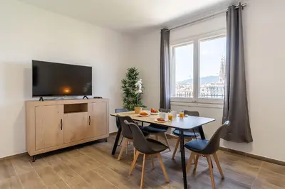 a dining room with a table with chairs and a tv at 4213 - AB Sagrada Familia Views VI-I in Barcelona