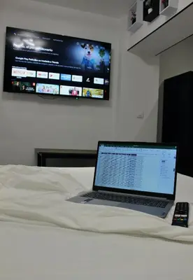 a laptop computer sitting on top of a bed at Work Stay in Gavà