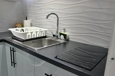 a kitchen with a sink and a counter top at Work Stay in Gavà