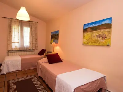a room with two beds and a painting on the wall at Holiday Home Can Trullas by Interhome in Viladecaballs