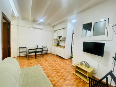 a living room with a couch and a flat screen tv at 030 apartameto 4-1 in Barcelona