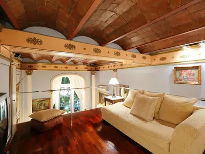 a living room with a couch and a wooden ceiling at Apartment Plaza de Catalunya - Pso- de Gracia by Interhome in Barcelona