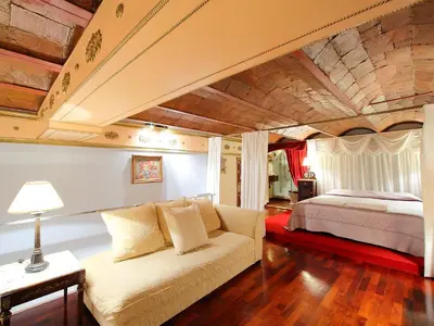 a living room with a couch and a bed at Apartment Plaza de Catalunya - Pso- de Gracia by Interhome in Barcelona