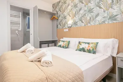 a bedroom with two beds with towels on them at Boutique Plaza Catalonia Suites Cornellá in Cornellà de Llobregat