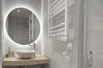 a bathroom with a sink and a mirror at Boutique Plaza Catalonia Suites Cornellá in Cornellà de Llobregat