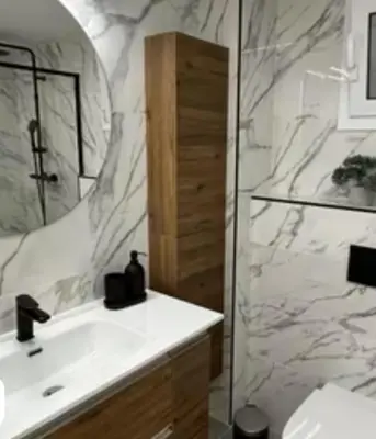 a bathroom with a white sink and a shower at Vidanova 2 in Vilanova i la Geltrú