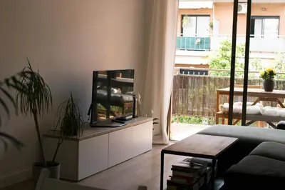 a living room with a flat screen tv on a cabinet at Barcelona a 20 minutos en piso reformado y soleado in Gavà