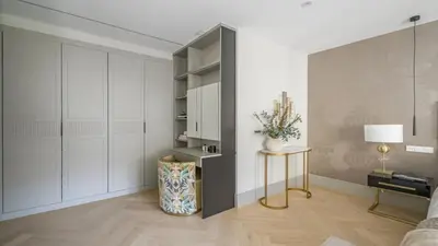 a living room with white cabinets and a table at Precioso Apartamento en Barcelona in Terrassa