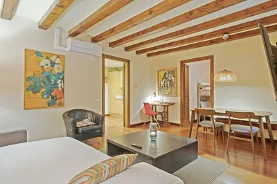 a living room with a couch and a table at Alcam Sombrerers in Barcelona