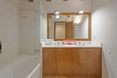 a bathroom with a sink and a tub and a mirror at Alcam Sombrerers in Barcelona