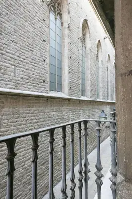 a building with a fence in front of a building at Alcam Sombrerers in Barcelona