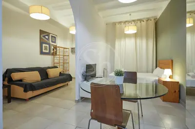 a living room with a glass table and a couch at Estudio en Gracia 2 in Barcelona
