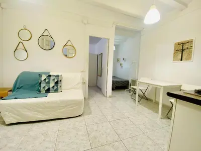 a living room with a bed and a desk in a room at 022 Center Barca 1,1 in Barcelona