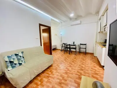 a living room with a bed and a table at 022 Center Barca 1,1 in Barcelona