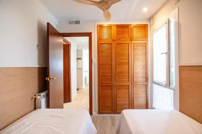 a bedroom with two beds and a window at Sitges frente al mar in Sitges