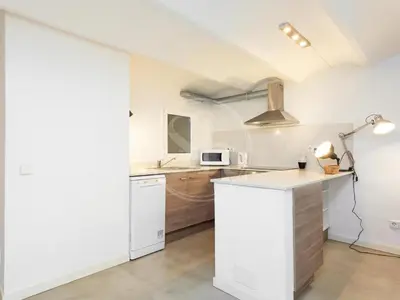 a dining room with a table and a television on a wall at Apartamento en Villarroel in Barcelona