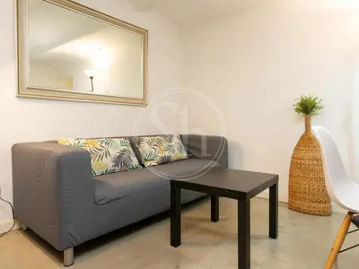 a living room with a table and a couch at Apartamento en Villarroel in Barcelona