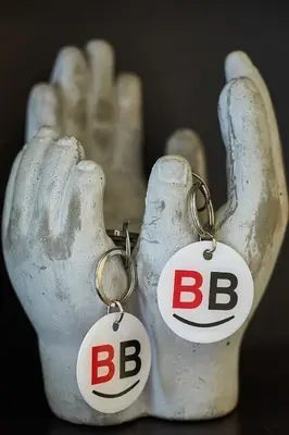 a pair of earrings with the letters bc on them at BBarcelona Rogent Flats in Barcelona