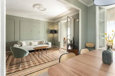 a living room with a white couch and a table at Spacious Stylish 4-bedroom Modernist Apartment in Barcelona