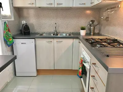 a kitchen with a sink and a stove at Apartamento La Mediterránea a 100 metros de la playa - Vilanova i la Geltrú - ES-332-1 in Vilanova i la Geltrú