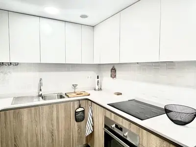 a kitchen with white cabinets and a sink at Apartamento Confortable con Parking Privado en el Centro de Vilanova i la Geltrú - ES-332-8 in Vilanova i la Geltrú