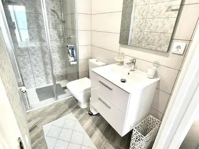 a bathroom with a toilet and a sink and a shower at Apartamento Confortable con Parking Privado en el Centro de Vilanova i la Geltrú - ES-332-8 in Vilanova i la Geltrú