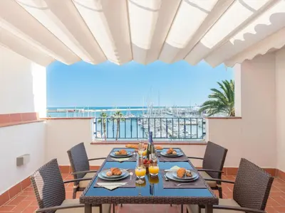 a dining room with a table and chairs at Ático Familiar Renovado Frente al Mar con Terraza y Vistas Panorámicas en Vilanova i la Geltrú - ES-332-2 in Vilanova i la Geltrú