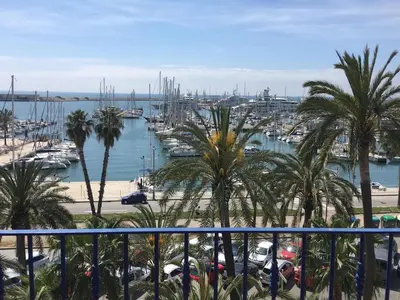 a view of a harbor with palm trees and a marina at Ático Familiar Renovado Frente al Mar con Terraza y Vistas Panorámicas en Vilanova i la Geltrú - ES-332-2 in Vilanova i la Geltrú