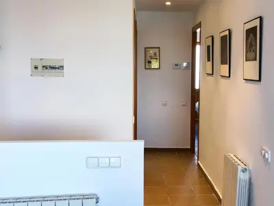 a room with a hallway with a white refrigerator at Ático Familiar Renovado Frente al Mar con Terraza y Vistas Panorámicas en Vilanova i la Geltrú - ES-332-2 in Vilanova i la Geltrú