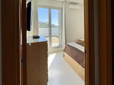 a small bedroom with a bed and a window at Casa espaciosa con piscina, aire acondicionado y jardín cerca de la playa de Vilanova - ES-332-9 in Sant Pere de Ribes