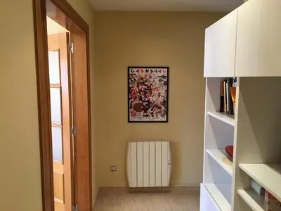 a hallway with a white radiator and a picture on the wall at Ático Increíble con Terraza Privada en el Centro de Vilanova i la Geltrú - ES-332-7 in Vilanova i la Geltrú