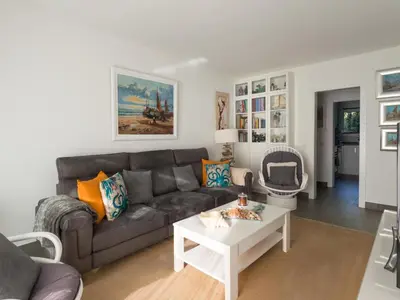 a living room with a couch and a table at Apartamento cómodo frente al mar con acceso directo a la playa - ES-332-6 in Vilanova i la Geltrú