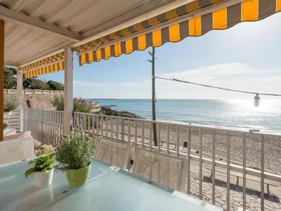 a balcony with a view of the beach at Apartamento cómodo frente al mar con acceso directo a la playa - ES-332-6 in Vilanova i la Geltrú
